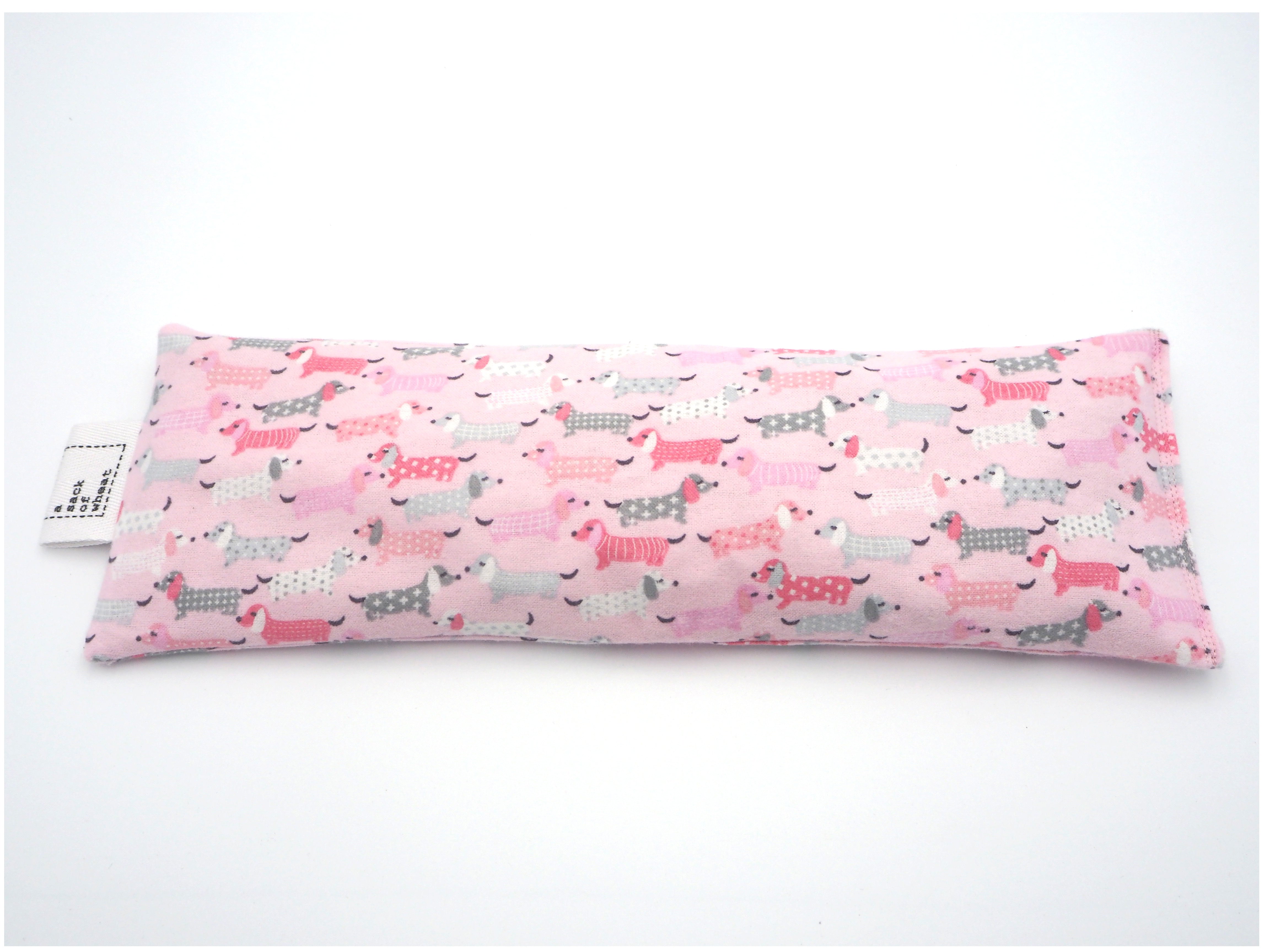 Flat view of A Sack Of Wheat, featuring pink, fluffy Dash Hounds on soft flannelette, 100% cotton fabric