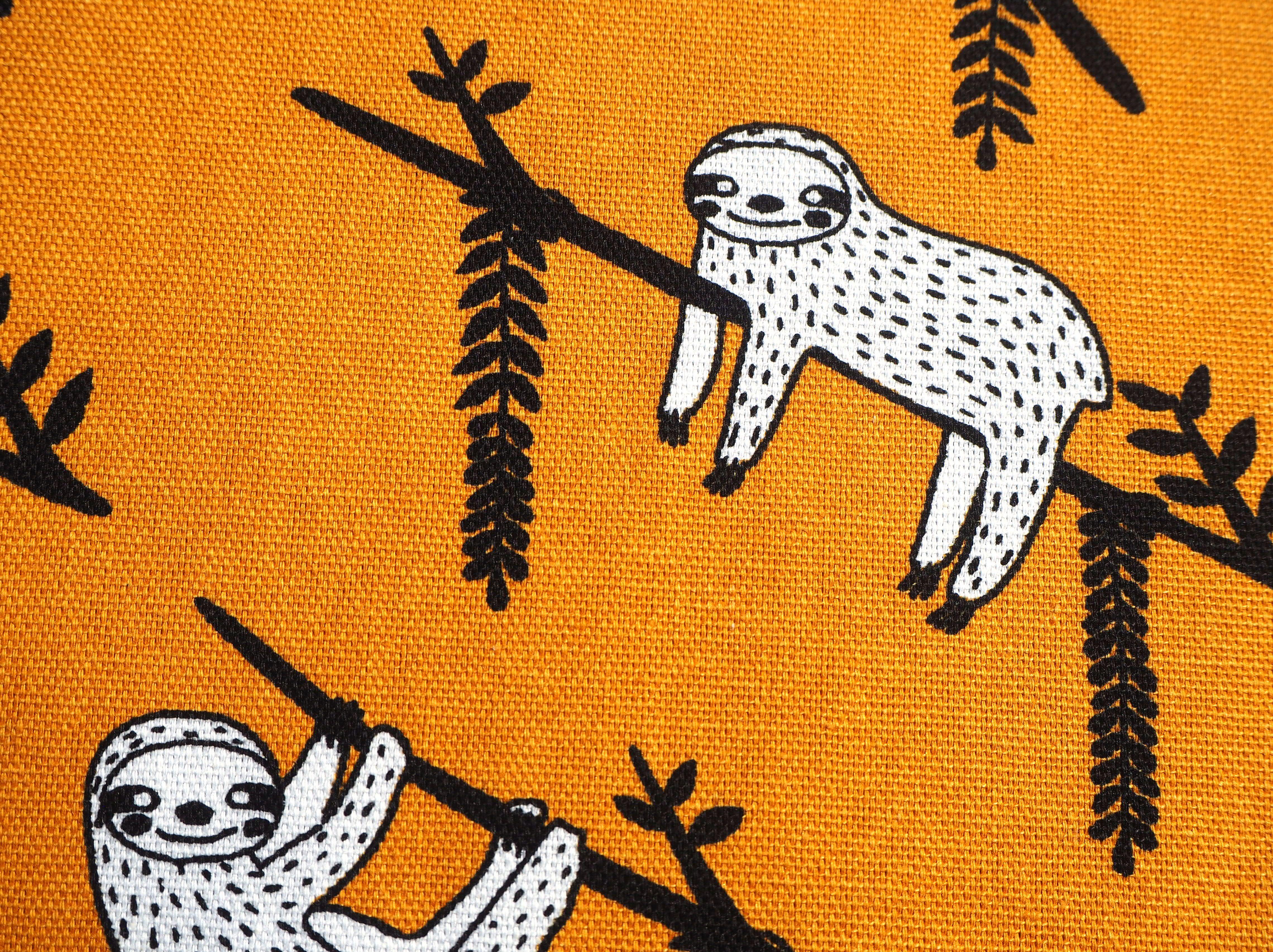 Hanging Around Sloth print on a mustard background, 100% cotton fabric