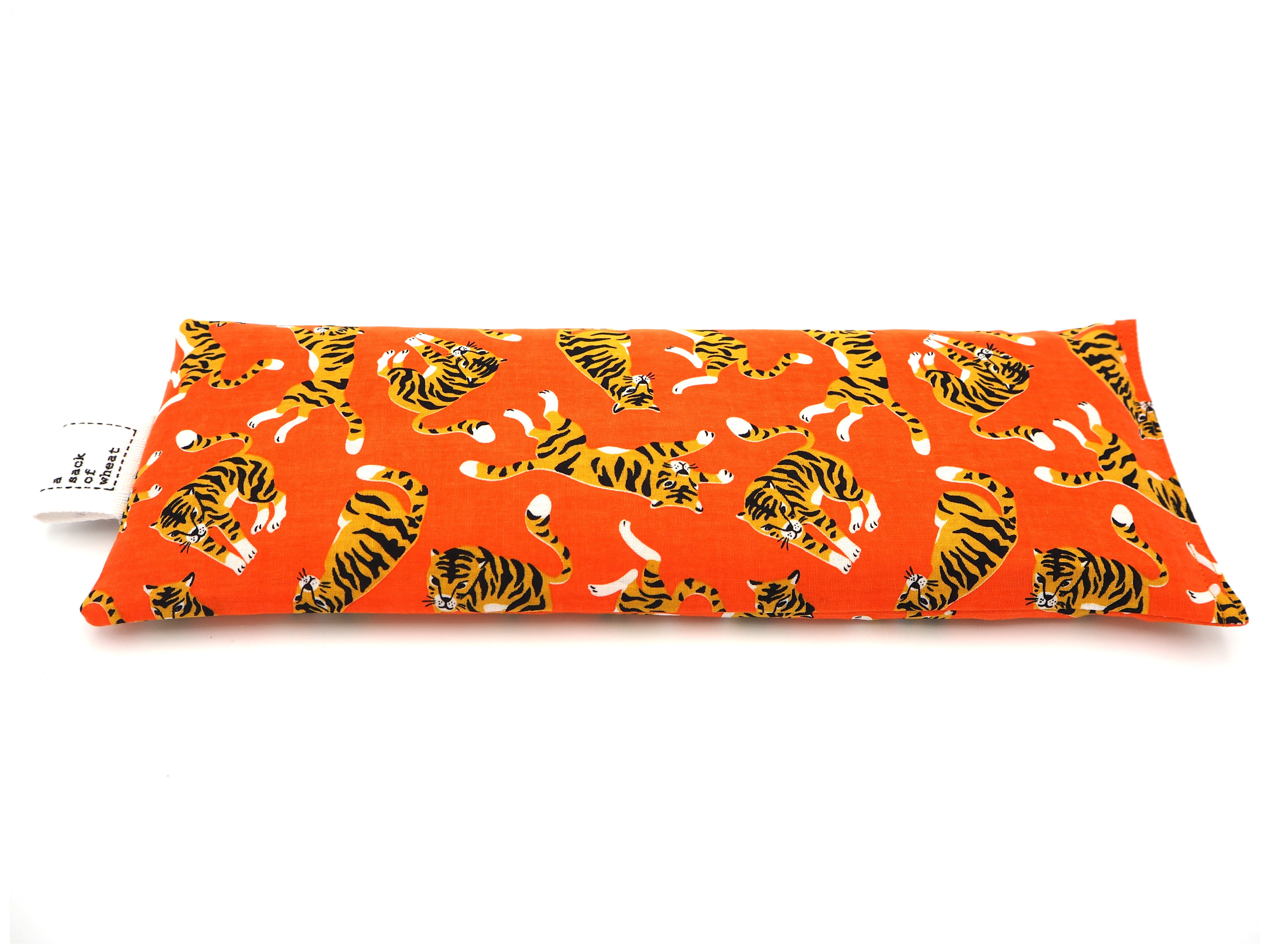 Flat view of A Sack Of Wheat, featuring  colorful tigers on bright orange fabric. 100% cotton fabric.