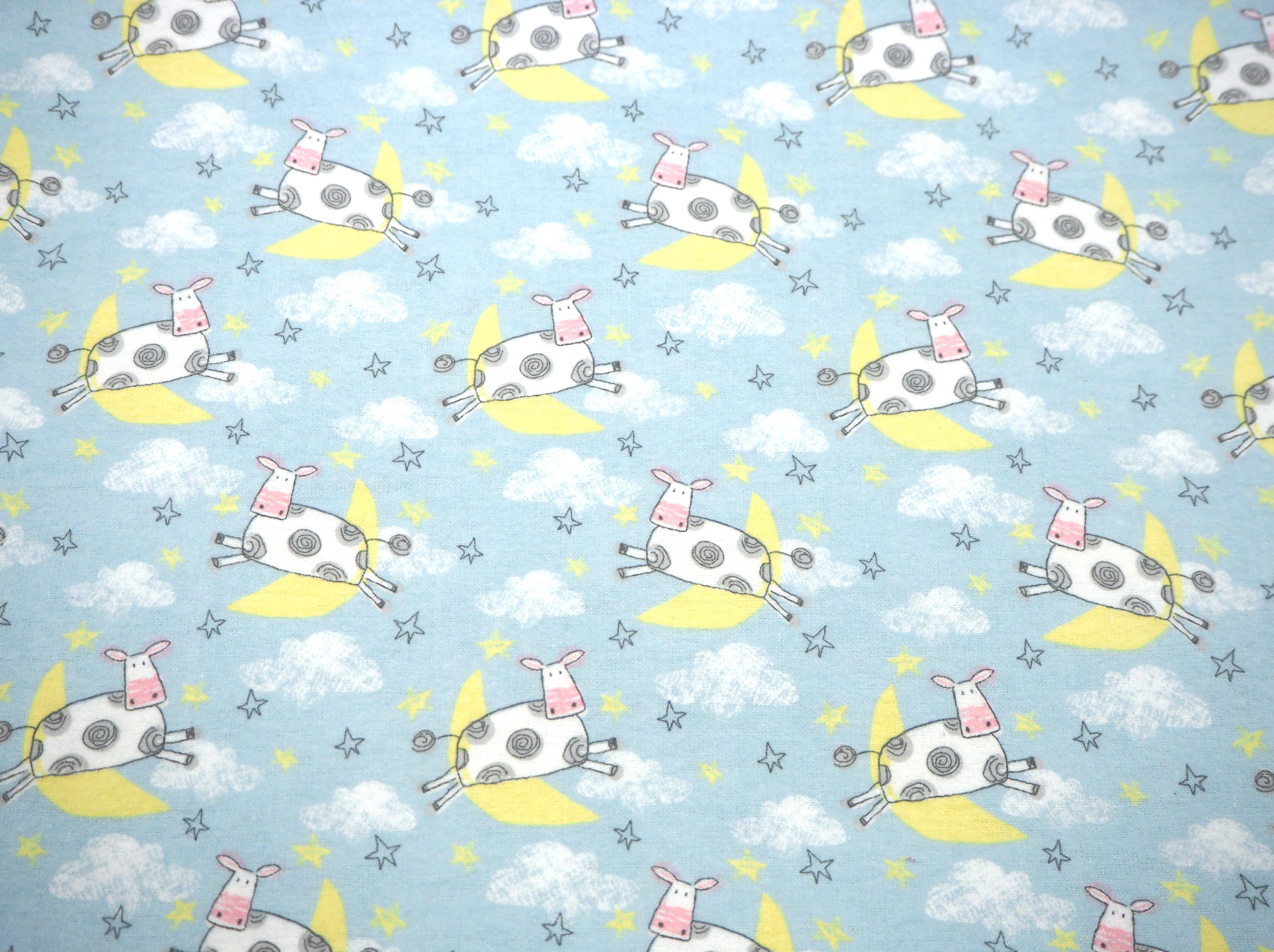 The Cow Jumped Over The Moon themed print on baby blue soft & fluffy flannelette cotton fabric