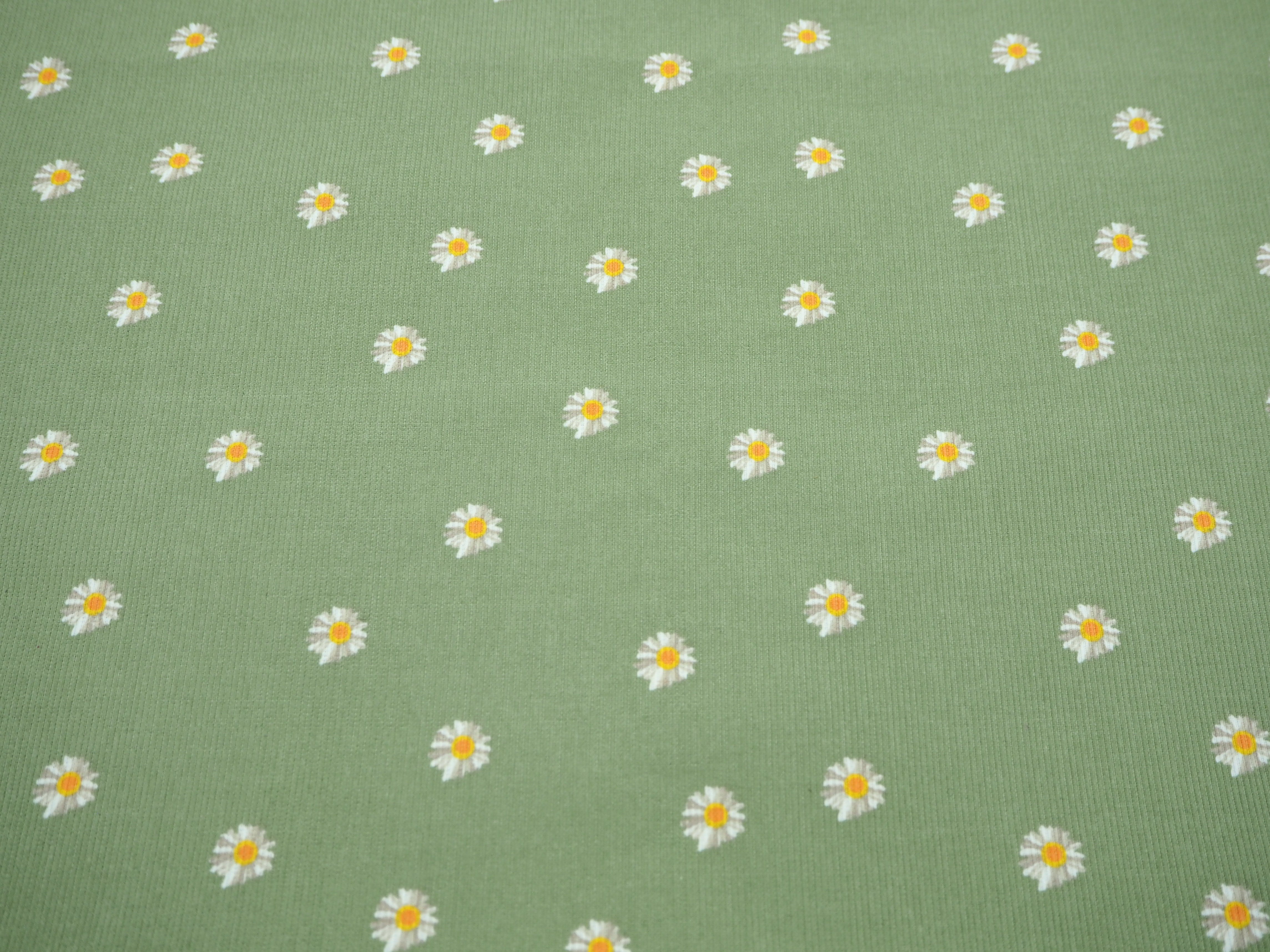Cute yellow & white daisy's in a field of sage green on soft corduroy 100% cotton fabric