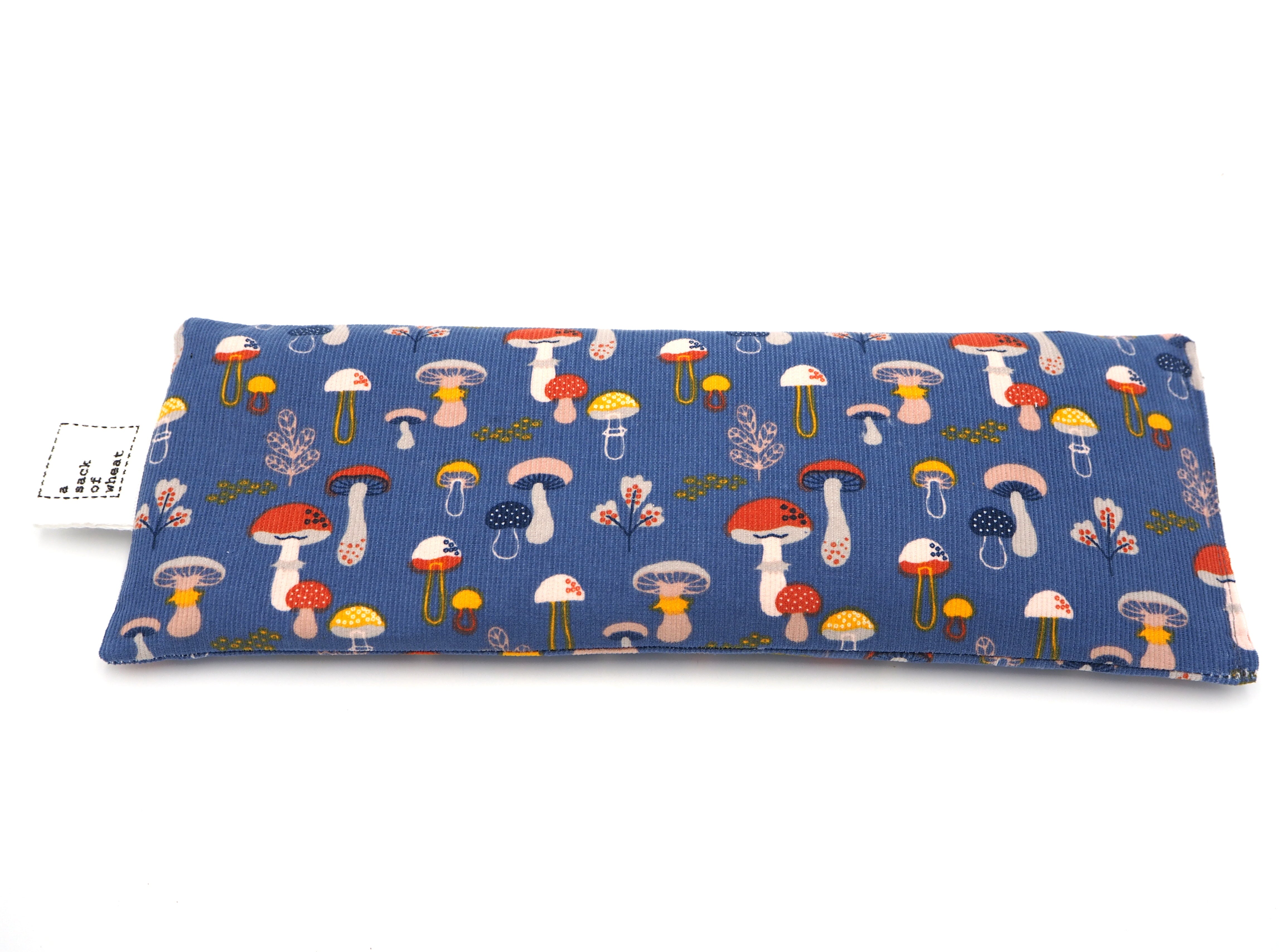 Flat view of A Sack Of Wheat, featuring cute, colorful mushrooms on blue corduroy 100% cotton fabric