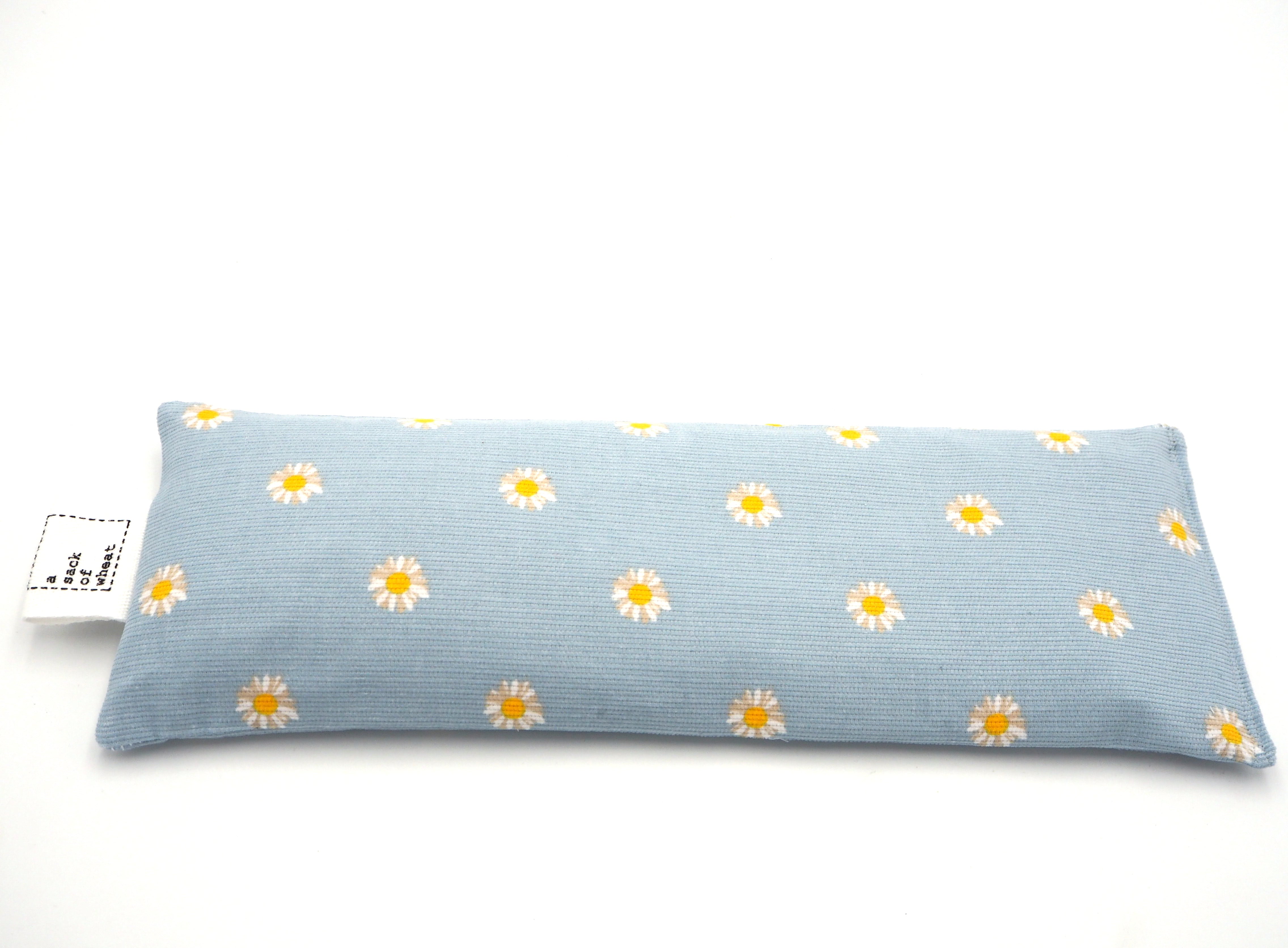 Flat view of A Sack Of Wheat, featuring soft yellow, spring daisy's on baby blue corduroy 100% cotton fabric