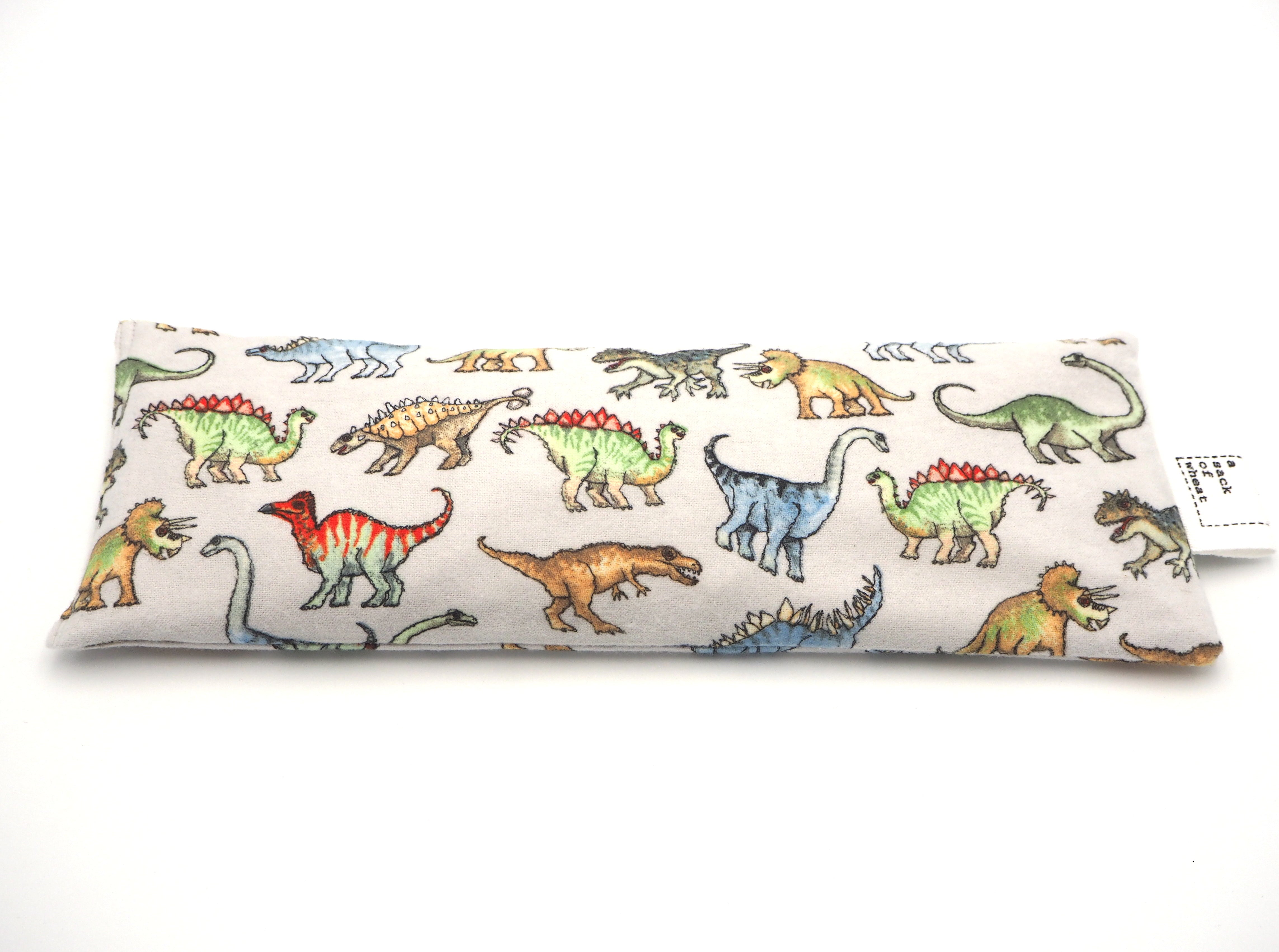 Flat view of A Sack Of Wheat, featuring colourful dinosaurs on flannelette, 100% cotton fabric