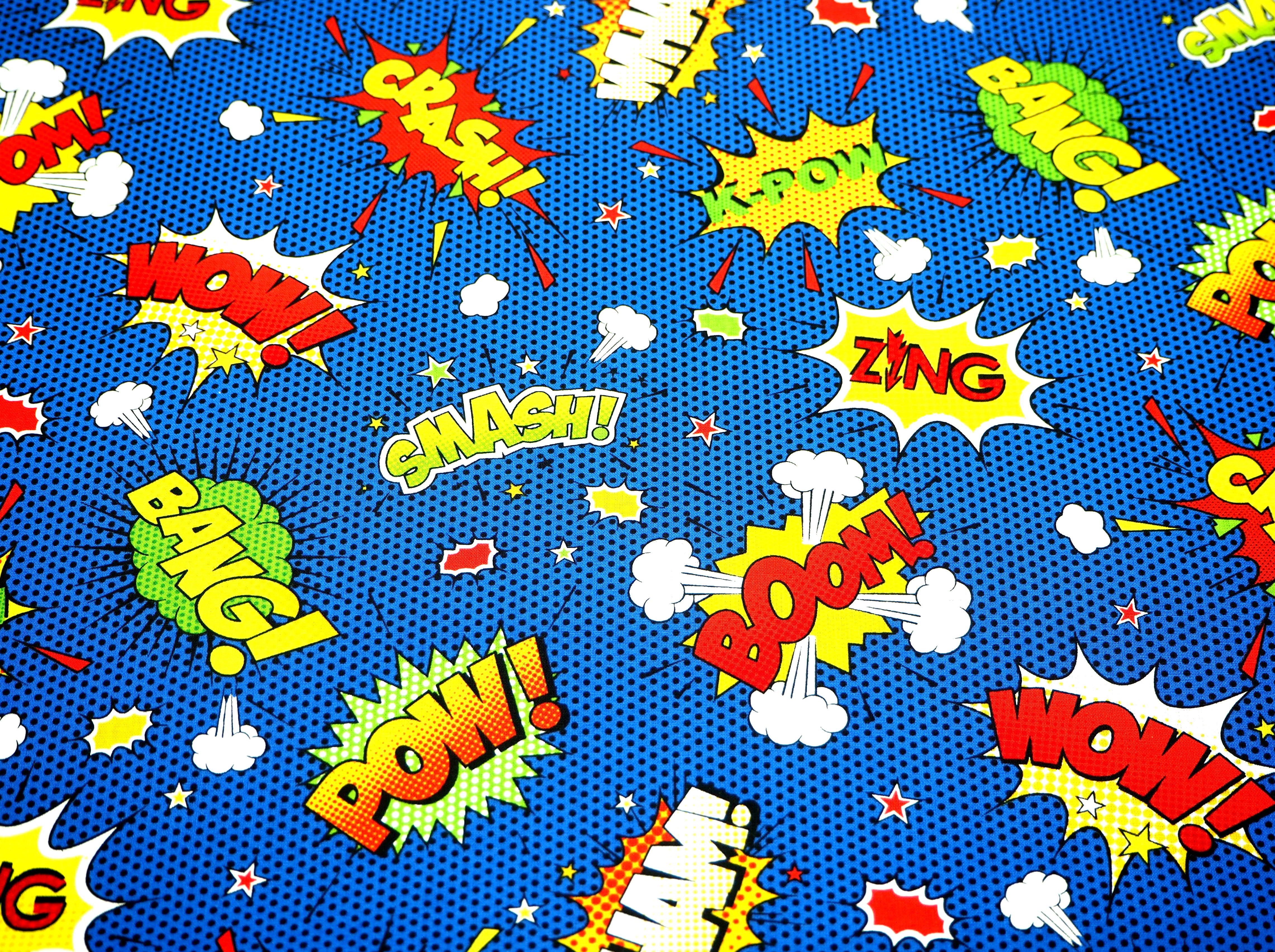 Fabric view featuring exploding words ( Crash, Smash, Pow & Wham!), on blue background, 100% cotton fabric