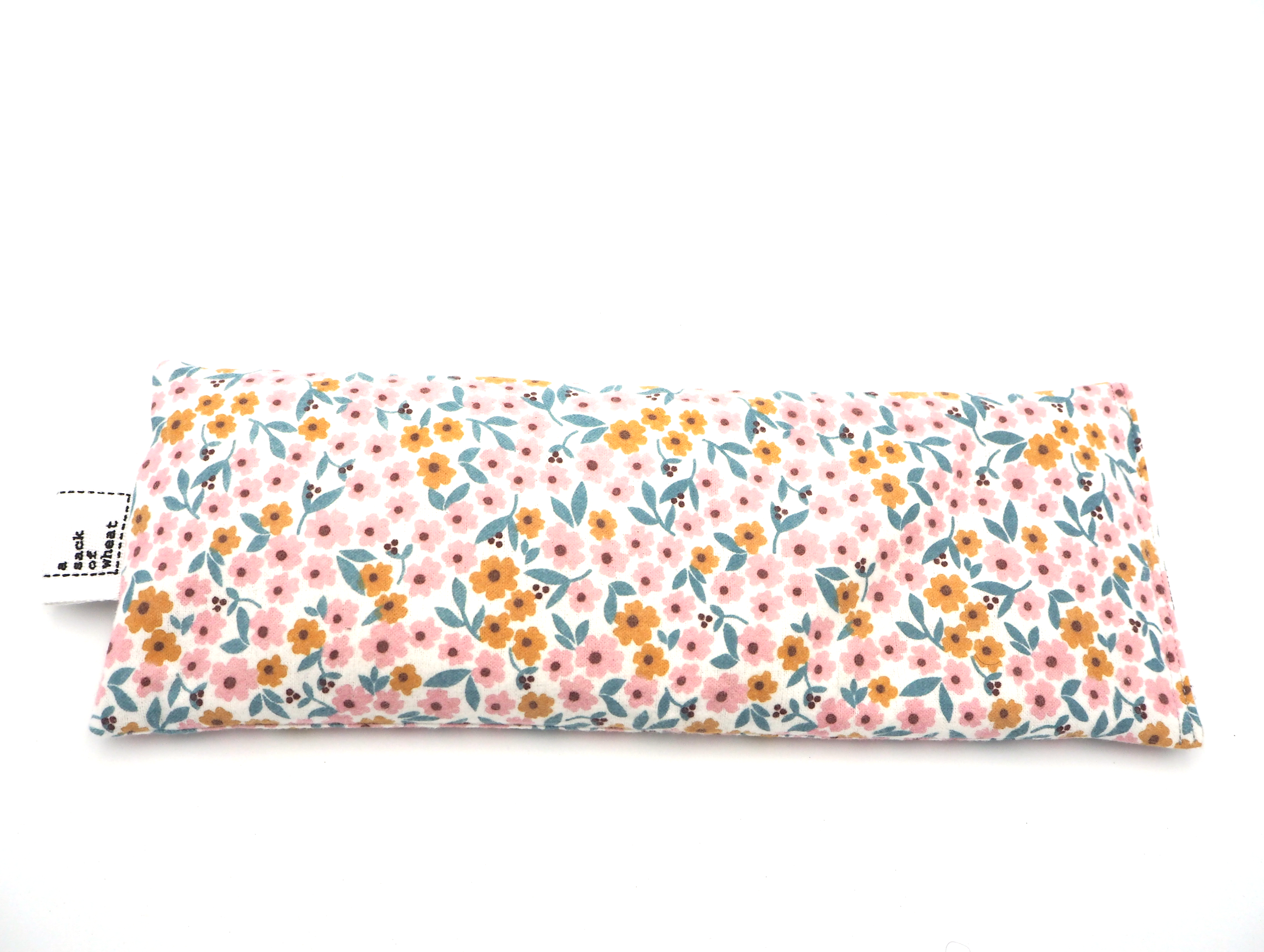 Floral patterned wheat bag on a white background