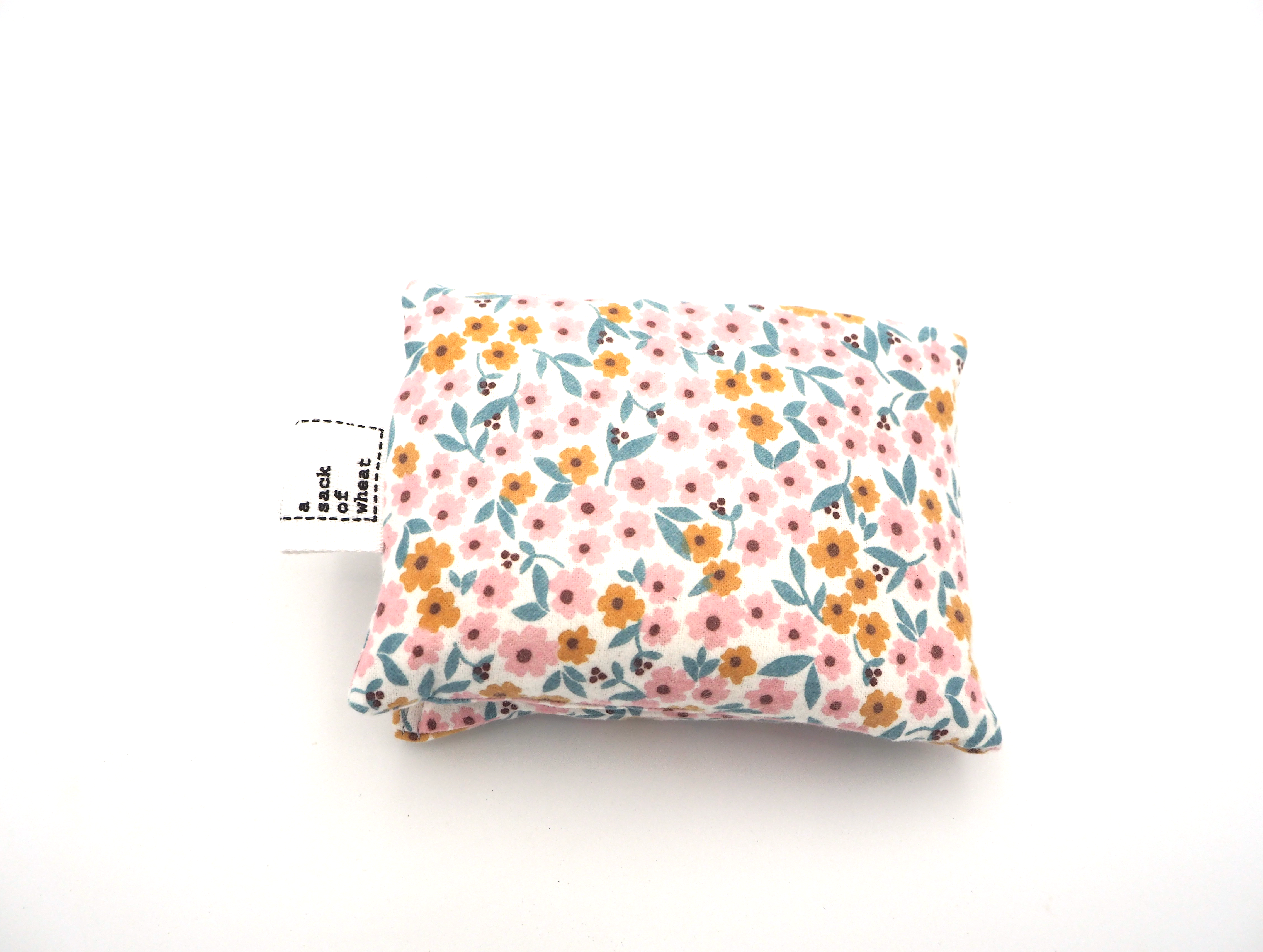 Floral patterned wheat bag on a white background, folded in half