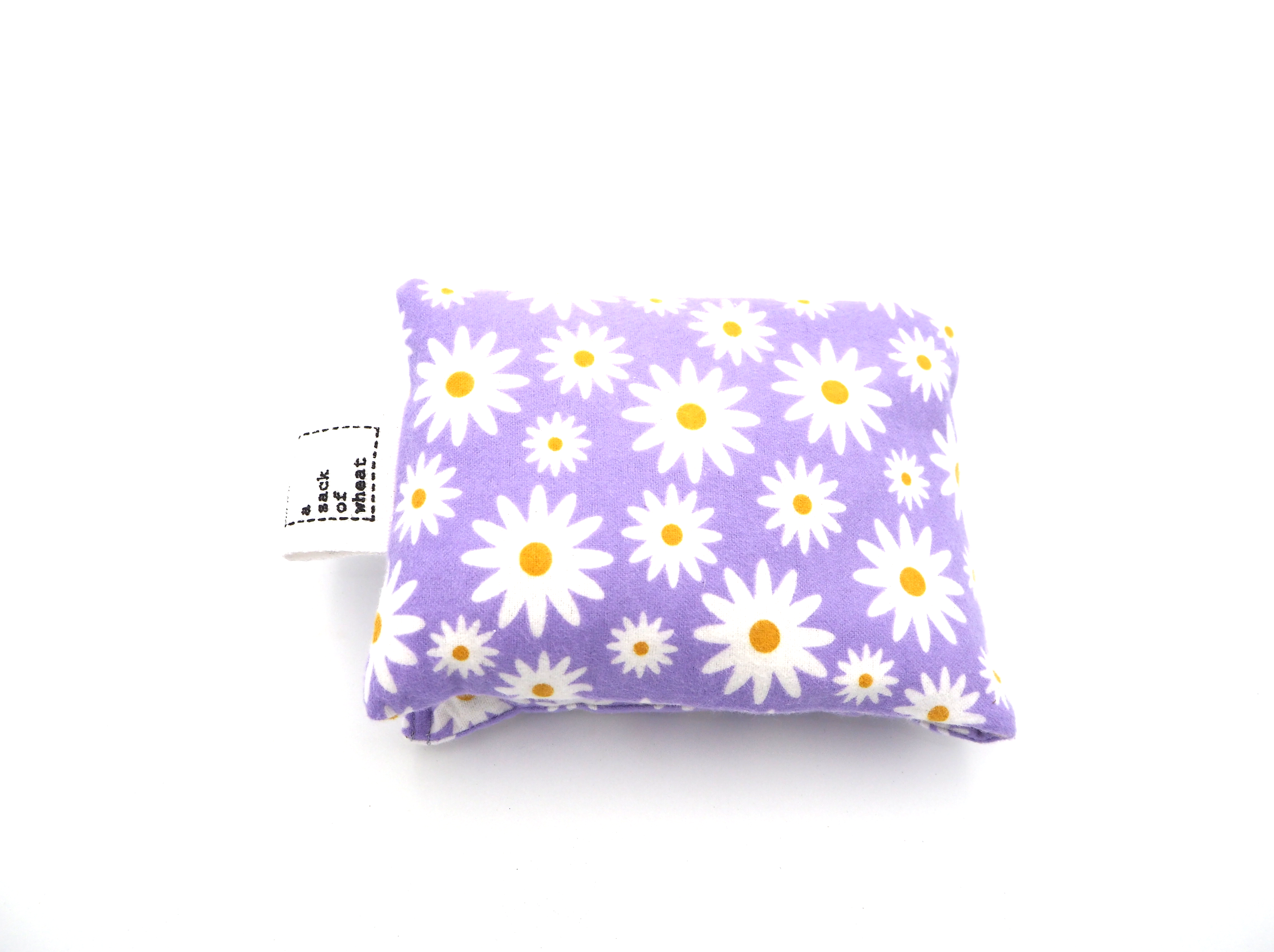 Wheat bag with white daisy pattern on a purple background