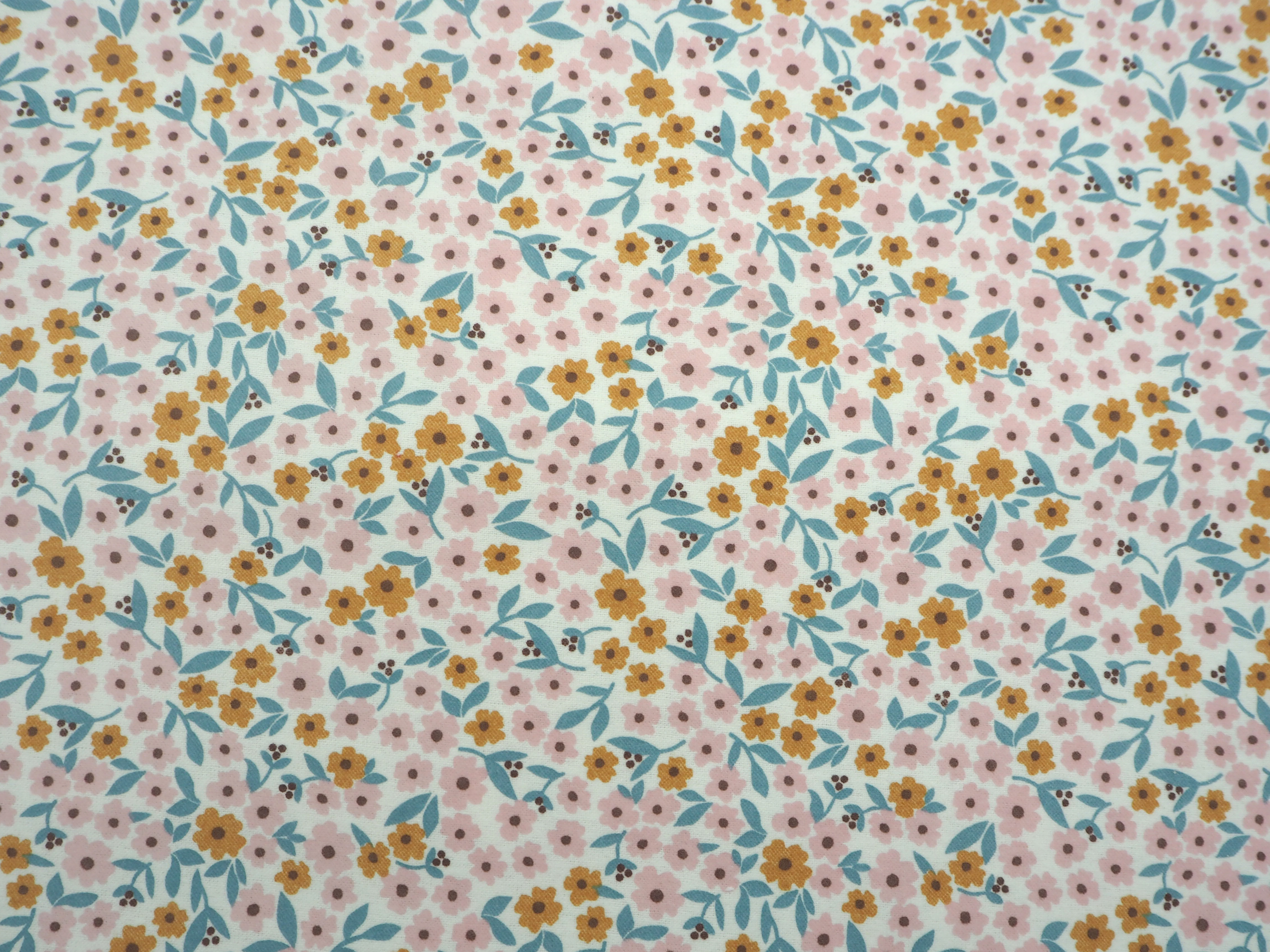 Floral pattern featuring soft pastel flowers on a white background, flannelette fabric