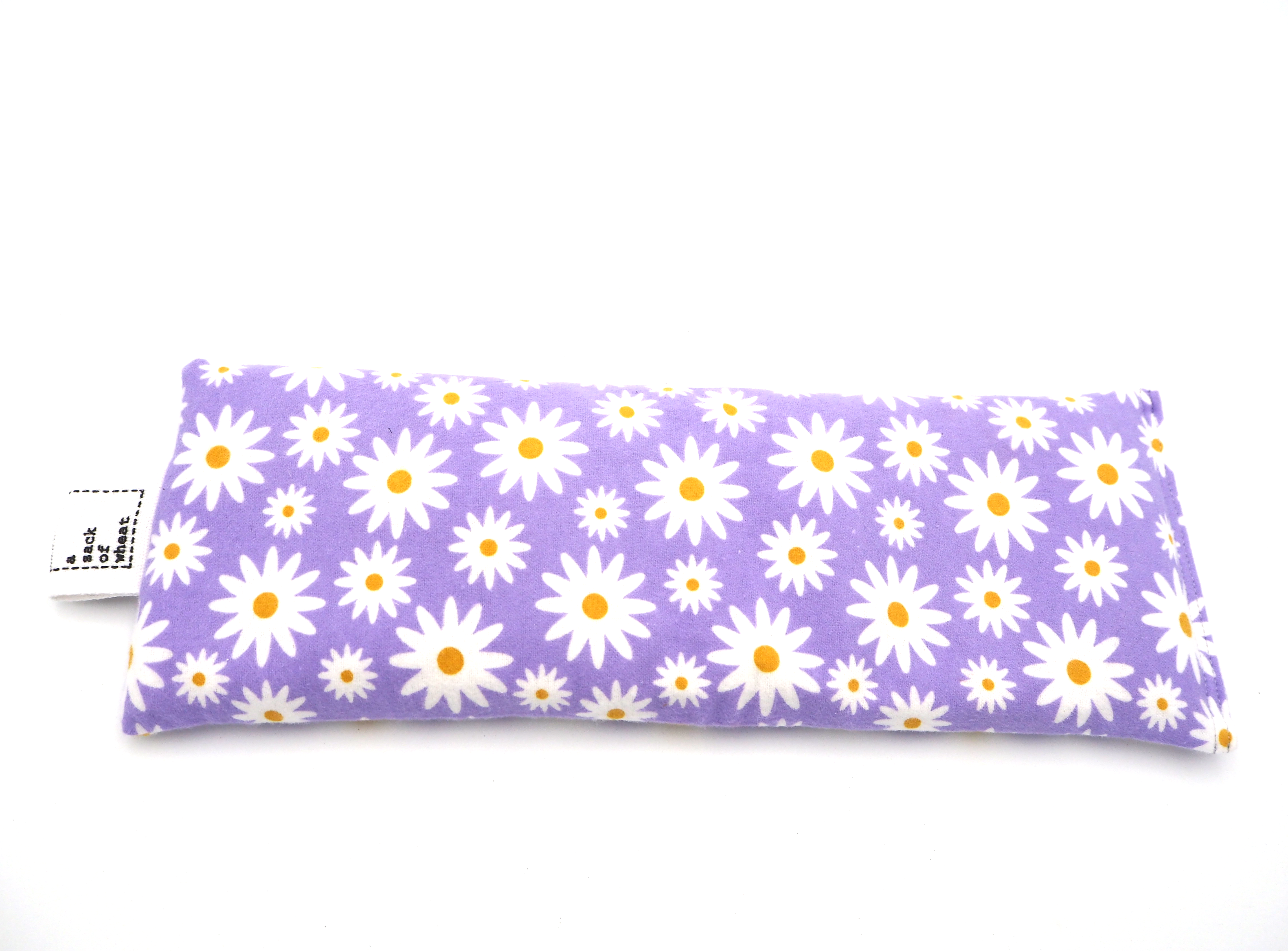 Wheat bag with white daisy pattern on a purple background