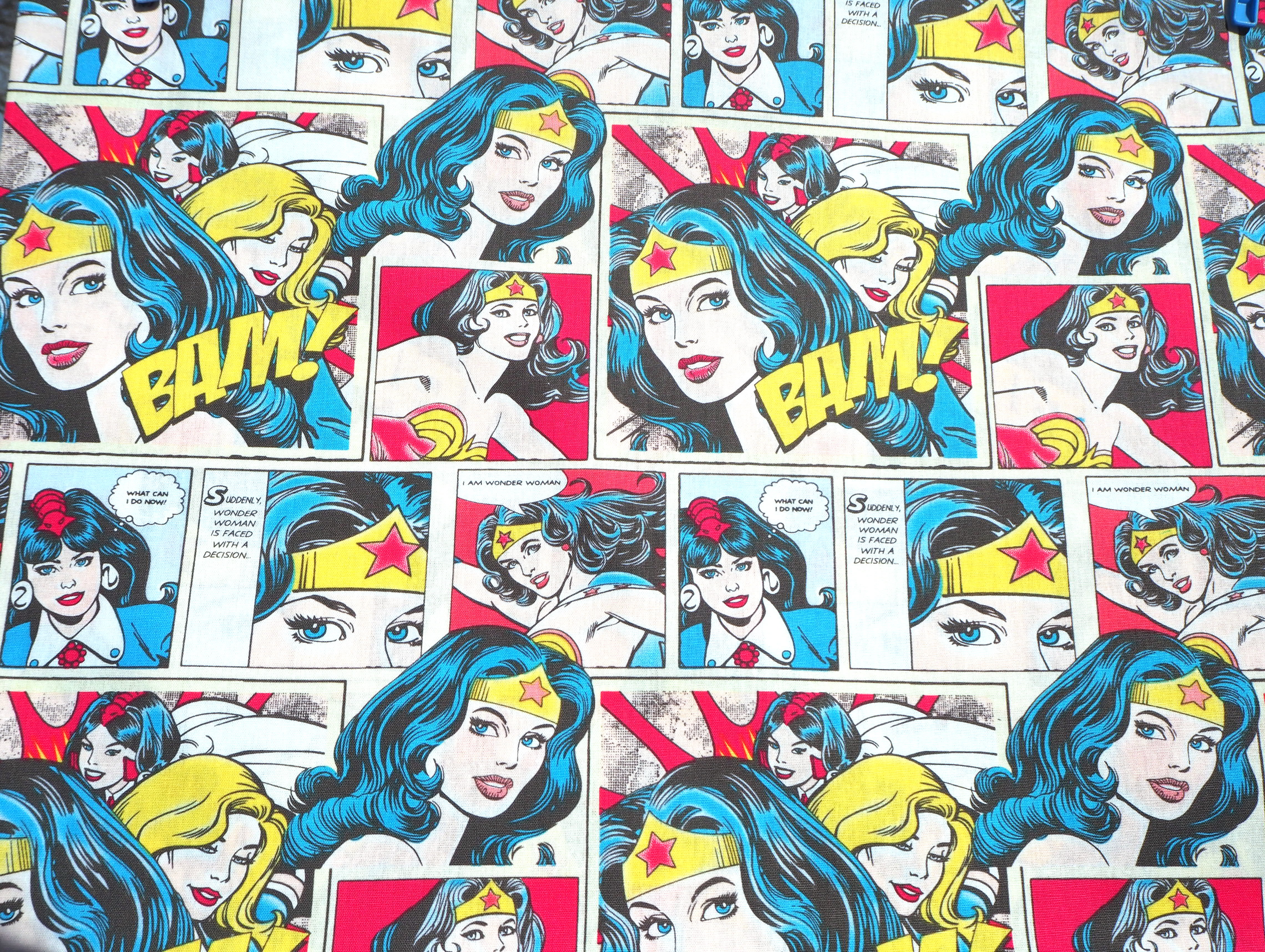 Fabric view of A Sack Of Wheat, featuring colorful comic book images, 100% cotton fabric