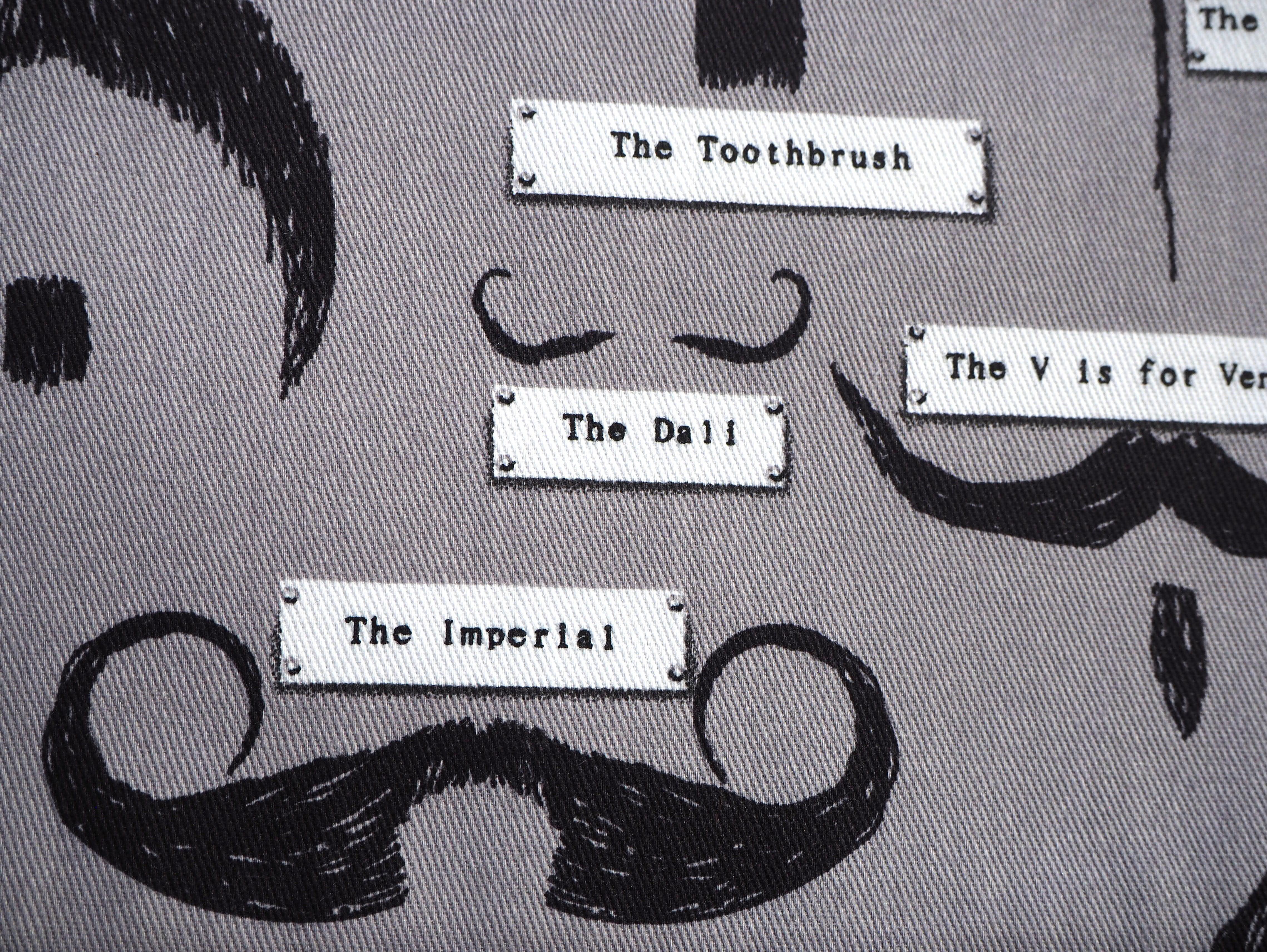 Selection of stylish Moustache's with their distinguished names on a grey background, 100% cotton fabric