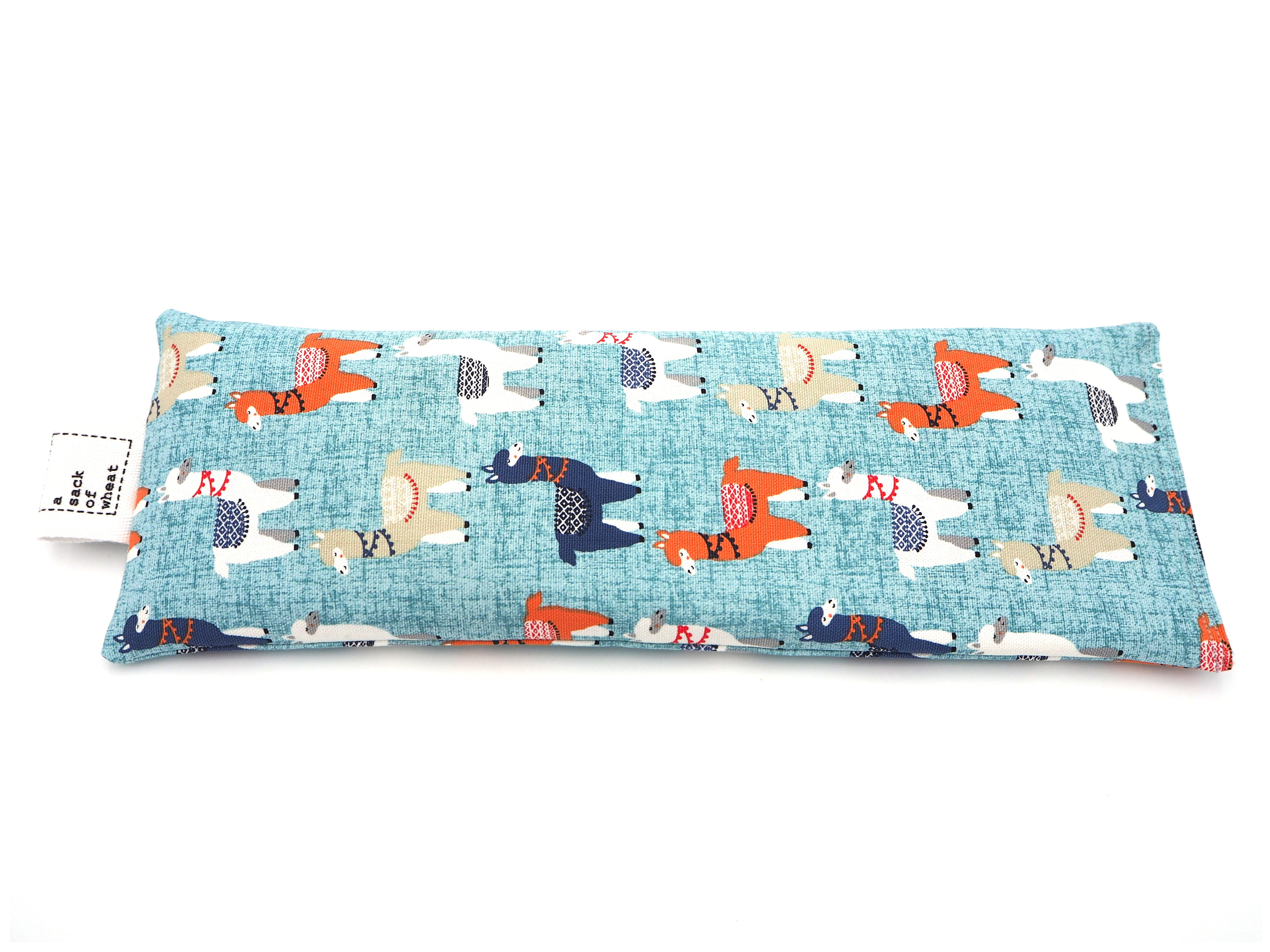 Flat view of A Sack Of Wheat, featuring colorful Llamas on soft blue background, 100% cotton fabric