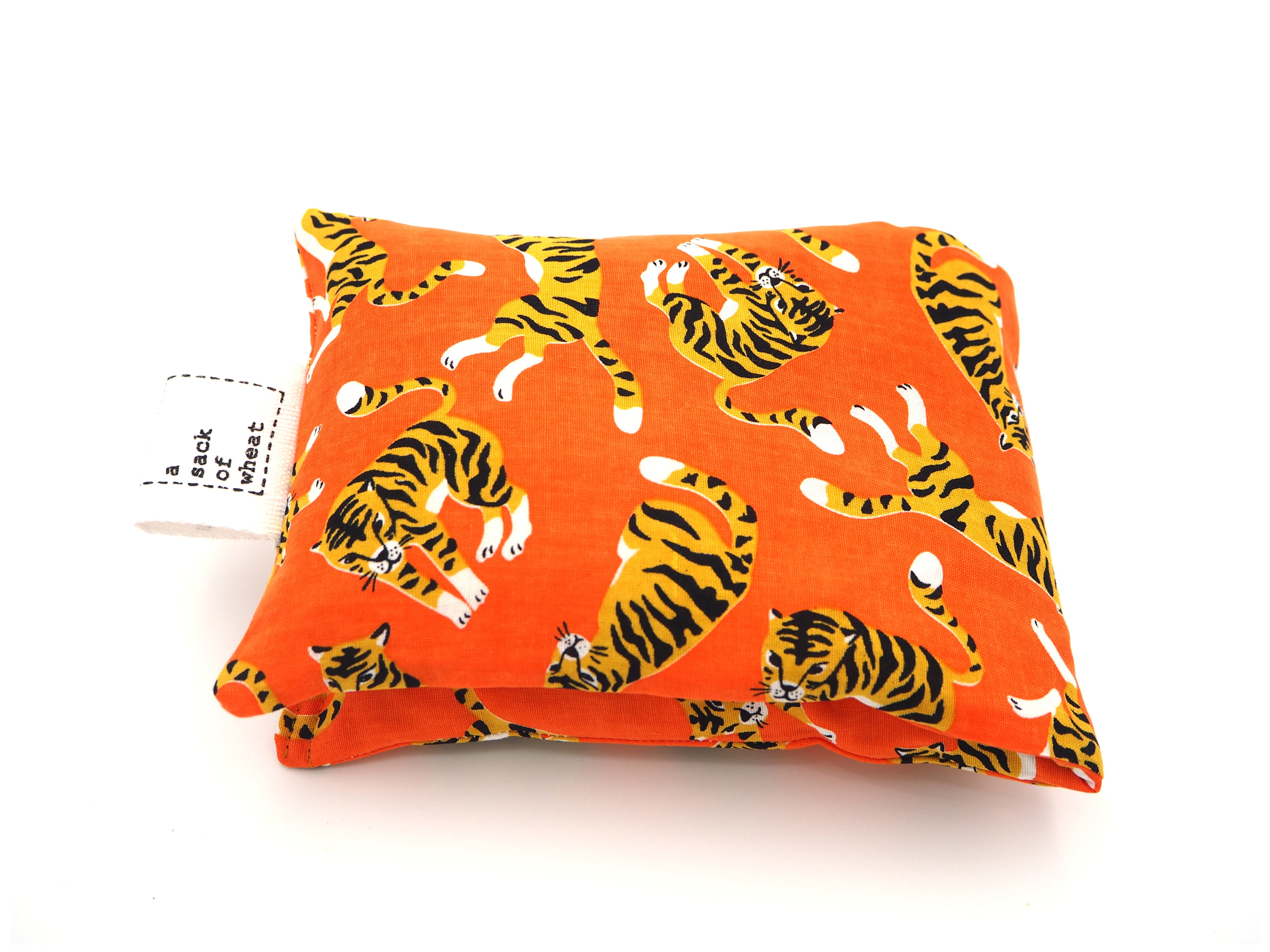 Folded view of A Sack Of Wheat, featuring  colorful tigers on bright orange fabric. 100% cotton fabric.