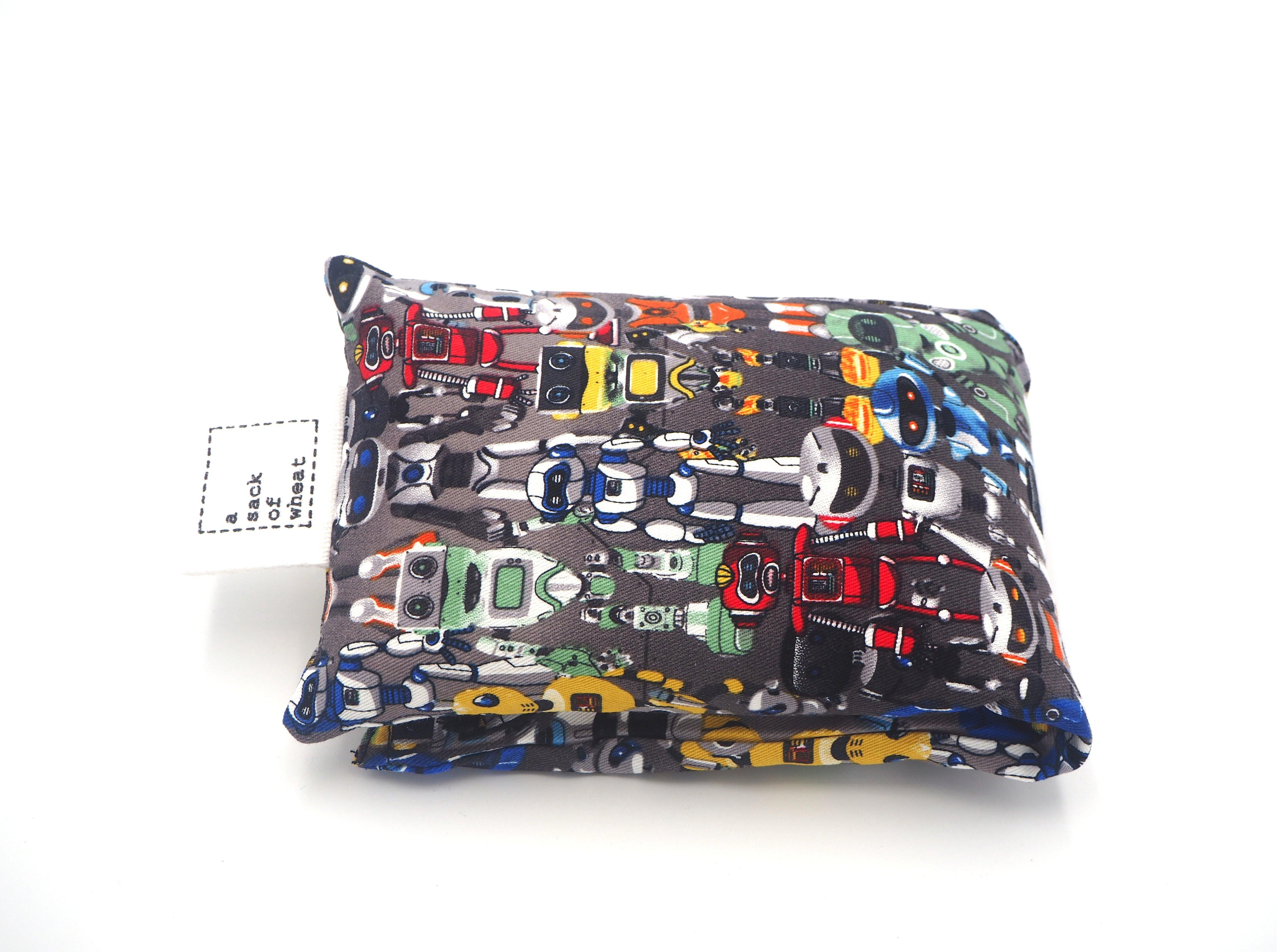 Folded view of A Sack Of Wheat, featuring colorful space age robot images on grey background, 100% cotton fabric