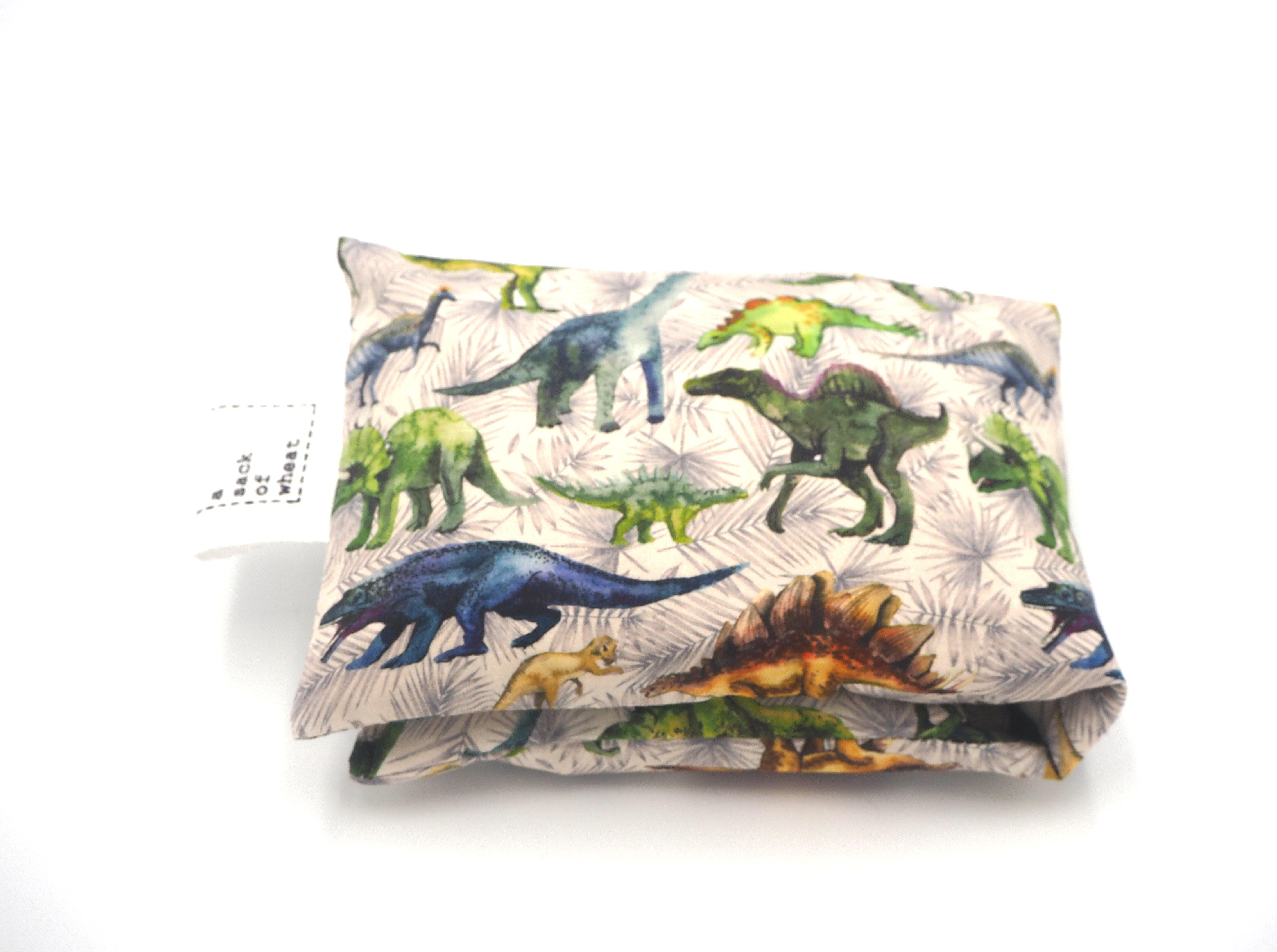 Folded view of A Sack Of Wheat, featuring colorful prehistoric Dinosaur print, 100% cotton fabric