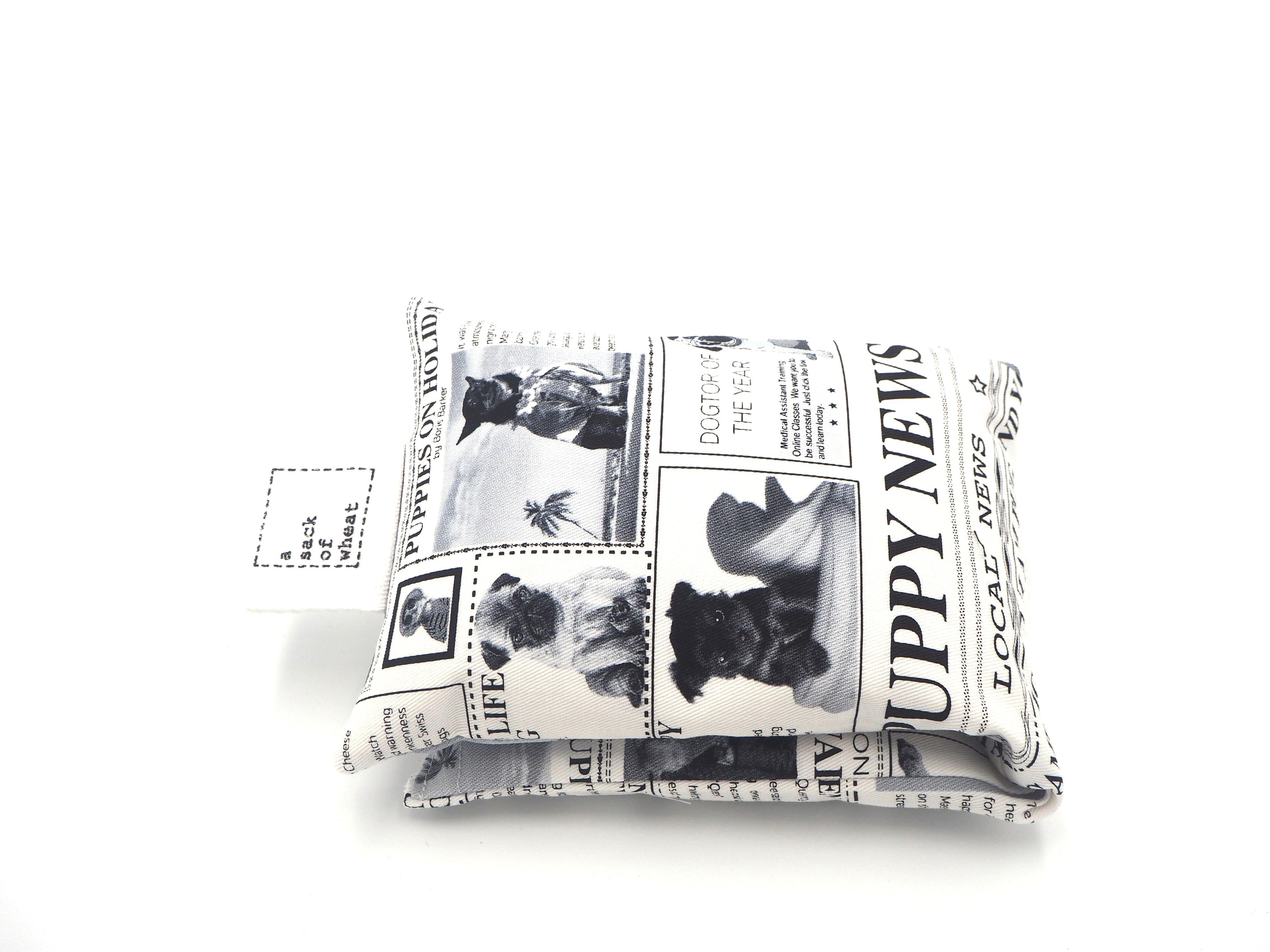 Folded view of A Sack Of Wheat, made from the Black & white news print featuring "All the News!" on Pugs & Puppy's. 100% cotton fabric