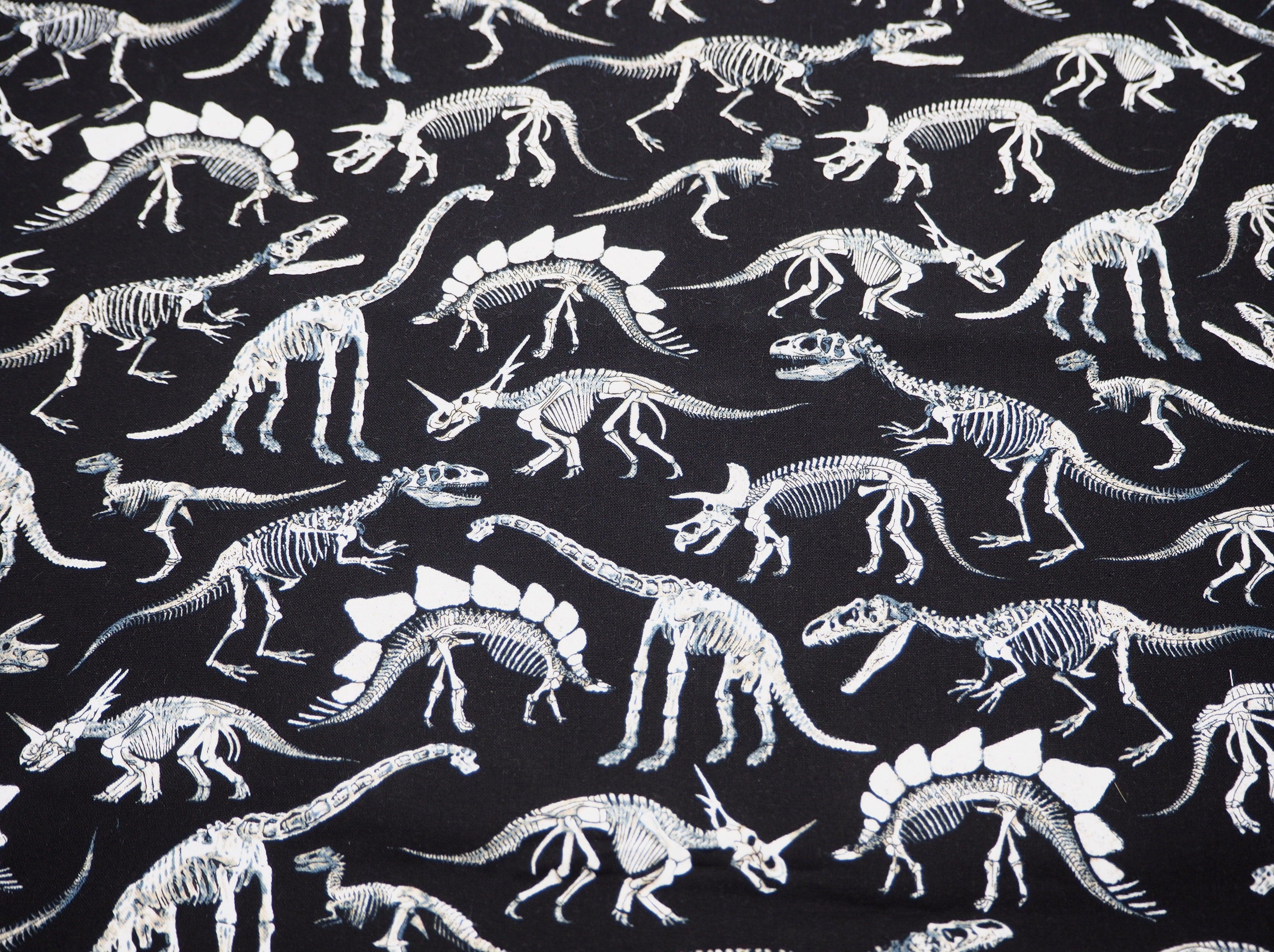 Fabric  view of A Sack Of Wheat, featuring black & white images of dinosaur skeletons on 100% cotton fabric
