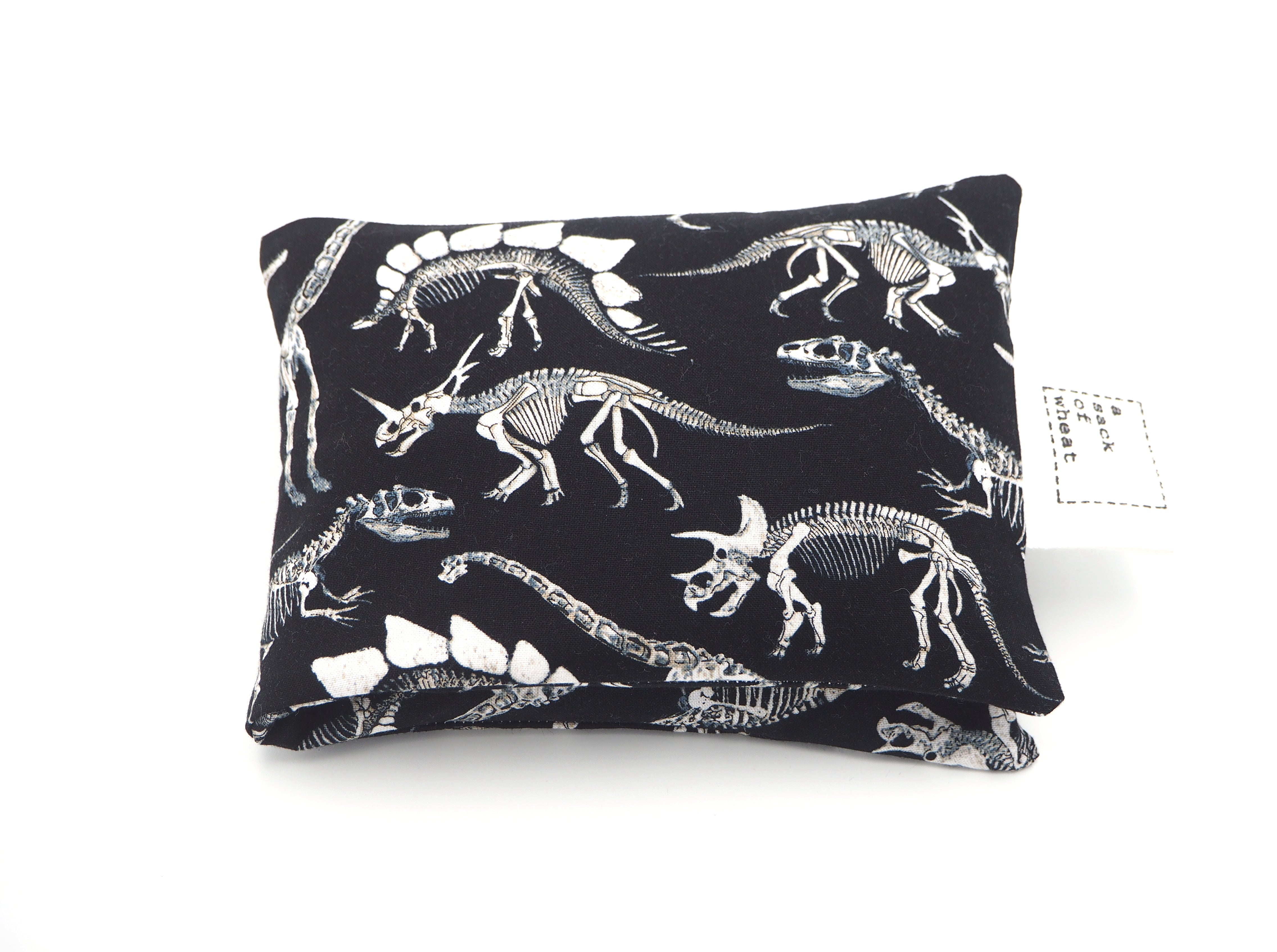 Folded view of A Sack Of Wheat, featuring black & white images of dinosaur skeletons on 100% cotton fabric