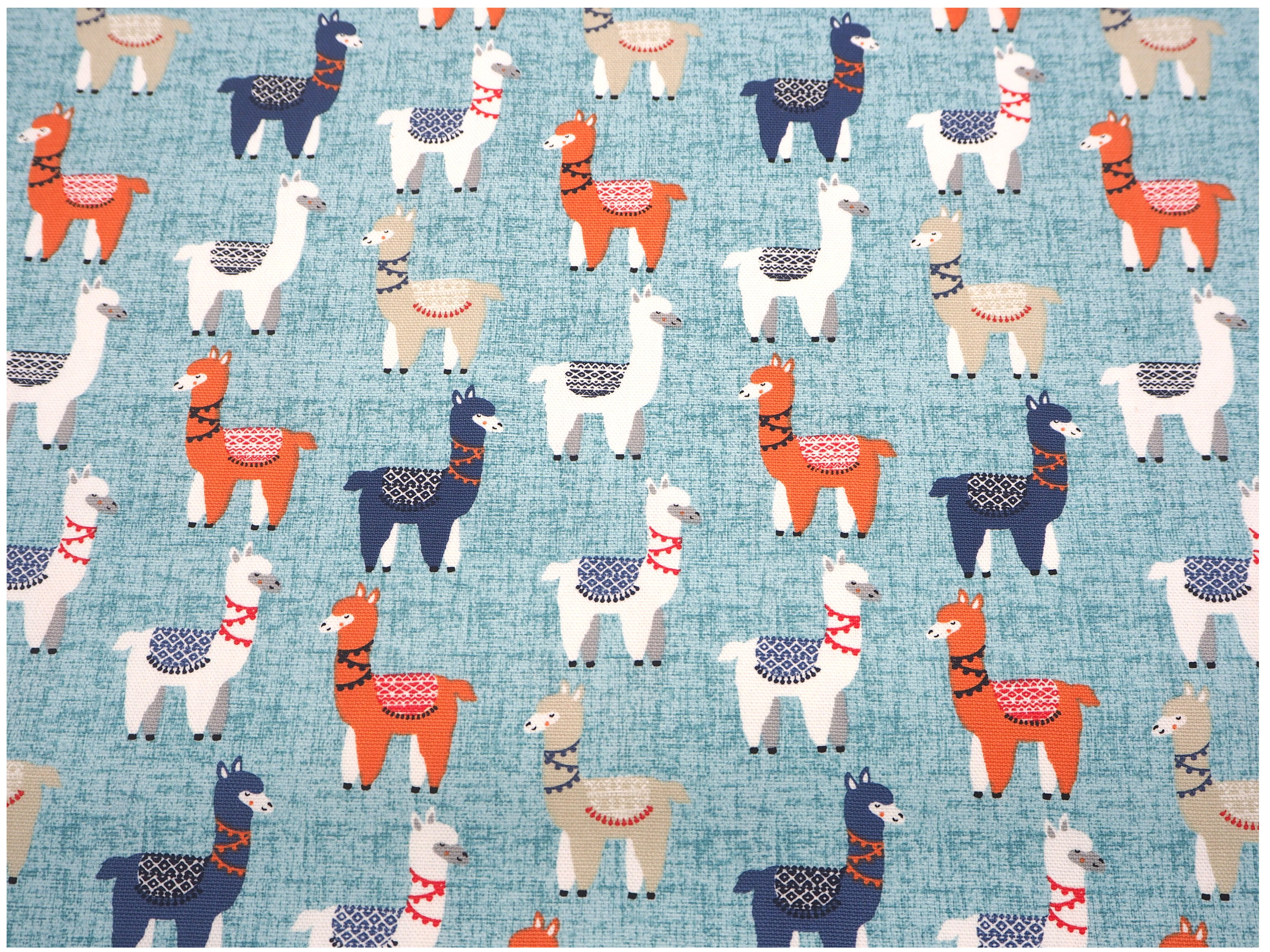 Fabric view of A Sack Of Wheat, featuring colorful Llamas on soft blue background, 100% cotton fabric